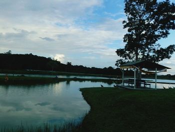 Scenic view of lake against cloudy sky