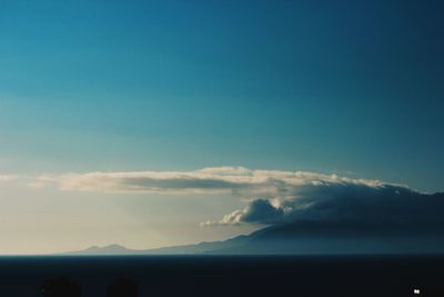 Scenic view of mountains against blue sky