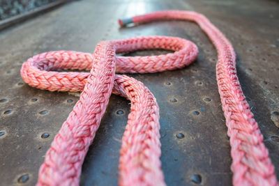 High angle view of pink tied on rope