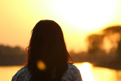 Rear view of woman during sunset