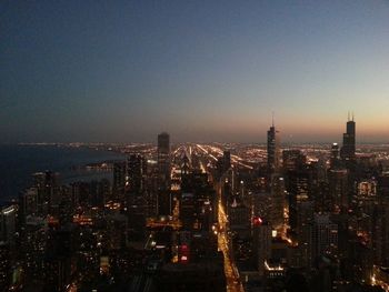 High angle view of city lit up at night