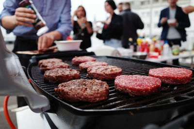 High angle view of people on barbecue grill