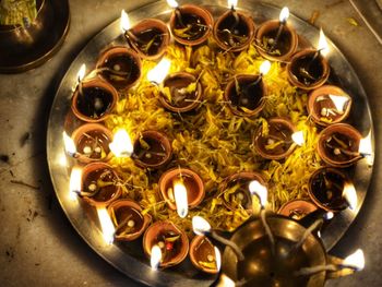 High angle view of illuminated candles in temple