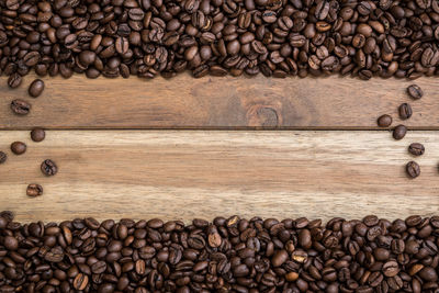 Directly above shot of roasted coffee beans on wooden table