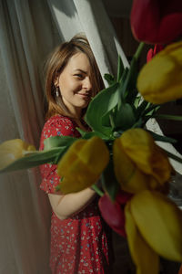 Young woman holding flower bouquet