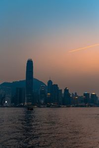 View of city at waterfront during sunset