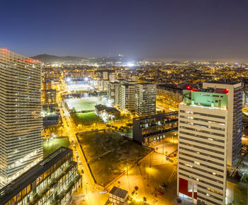 High angle view of city lit up at night