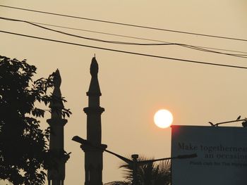 Low angle view of silhouette text against sky during sunset