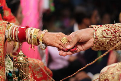 Cropped image of couple holding hands