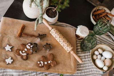 Homemade ginger christmas cookies decorated with icing lies on the table in rustic style