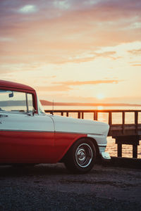 Car on street against sky during sunset