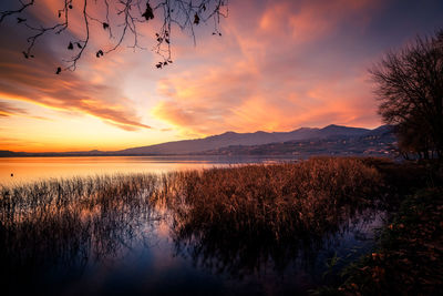 Scenic view of lake against sky during sunset