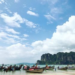 Boats moored in sea against sky