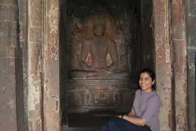 Portrait of a smiling young woman sitting outdoors