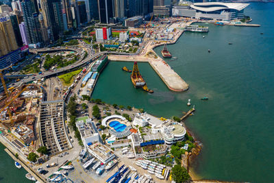 Aerial view of city by sea against sky