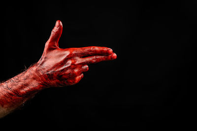 Close-up of human hand against black background