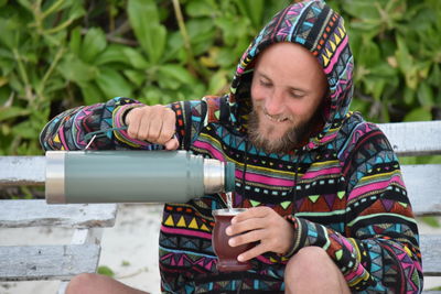 Portrait of young woman sitting outdoors