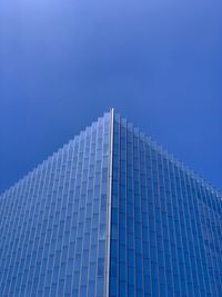 Low angle view of modern building against clear blue sky