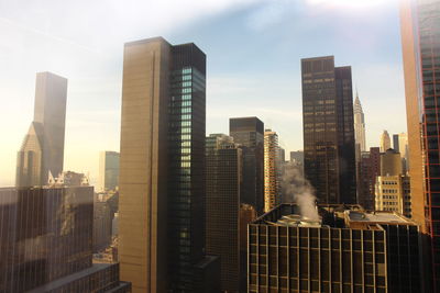 Skyscrapers in city against sky