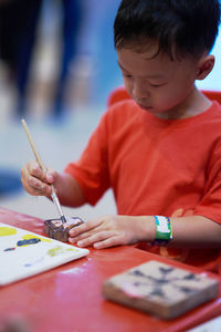 Boy making drawing on table