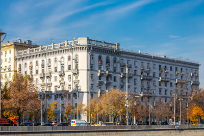 Street by buildings against sky in city