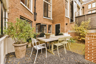 Empty chairs and tables in yard