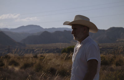 Side view of adult man in cowboy hat in desert. almeria, spain