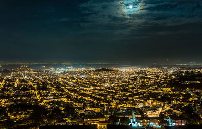 High angle view of illuminated cityscape against sky at night