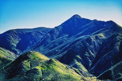 Scenic view of mountains against clear blue sky