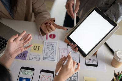 Midsection of business colleagues working on table