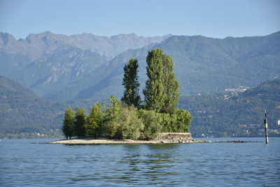 Scenic view of lake and mountains against clear sky