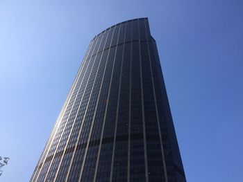 Low angle view of modern building against clear blue sky