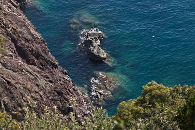 High angle view of rocks on sea