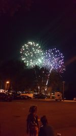 Low angle view of firework display at night