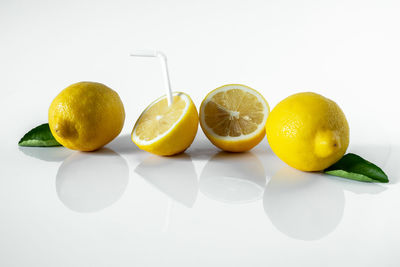 Close-up of fruits on table against white background