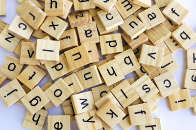 Alphabets on wood over white background