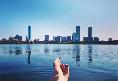 Barefoot by charles river against buildings in boston