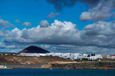 Sea and buildings against sky