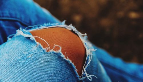 Close-up of ripped jeans