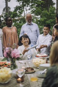 Portrait of smiling friends enjoying picnic