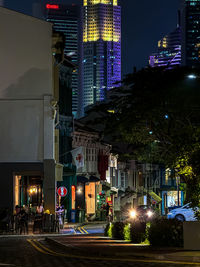 Illuminated city street at night