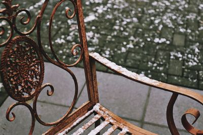 Close-up of snowy bench