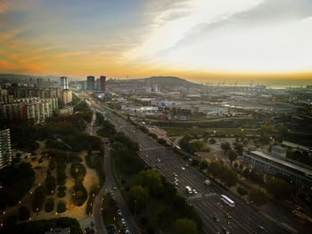 Aerial view of road and cityscape during sunset