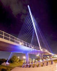 Low angle view of illuminated bridge against sky at night