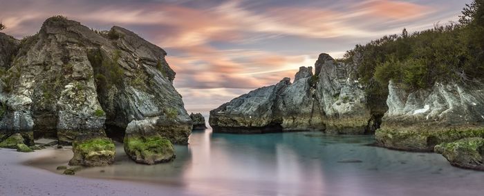 Panoramic view of rock formation in sea against sky