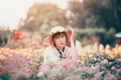 Portrait of woman wearing hat on field