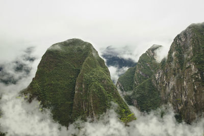 Majestic view of clouds covering green mountains at machu picchu