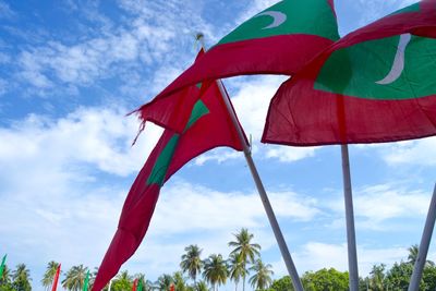 Low angle view of flags against sky