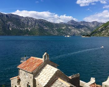 Scenic view of sea and mountains against sky