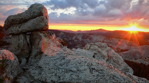 Rock formation against sky during sunset